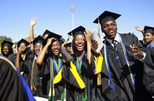 Students react during the graduation ceremony of the 2010 class at Hampton University in Virginia May 9, 2010. U.S. President Barack Obama delivered the commencement address at the graduation and was conferred an honorary doctor of laws degree.     REUTERS/Jason Reed   (UNITED STATES - Tags: POLITICS EDUCATION IMAGES OF THE DAY) - RTR2DNV8